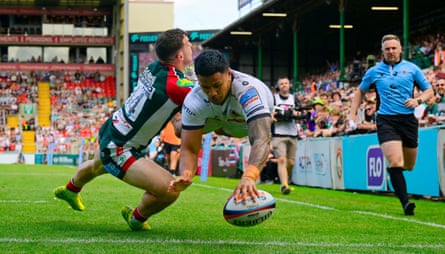 Len Ikitau holds off Adam Radwan to score for Exeter