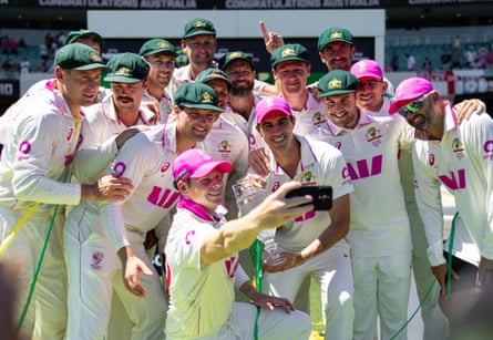 Australia’s players enjoy a moment with the Ashes crystal trophy after beating England in Sydney.