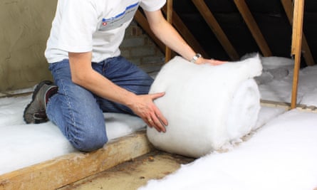 Man lays loft insulation