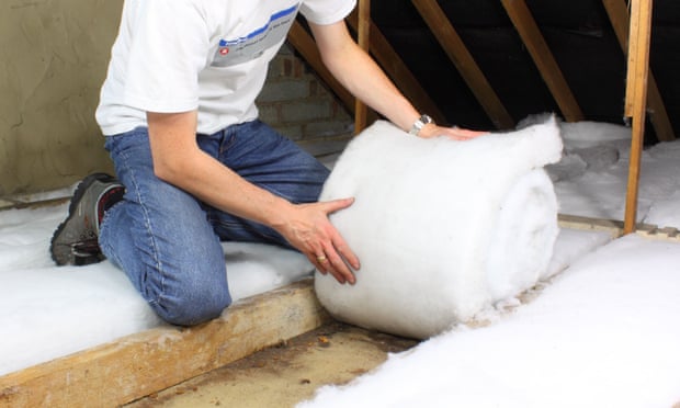 Man installs attic insulation