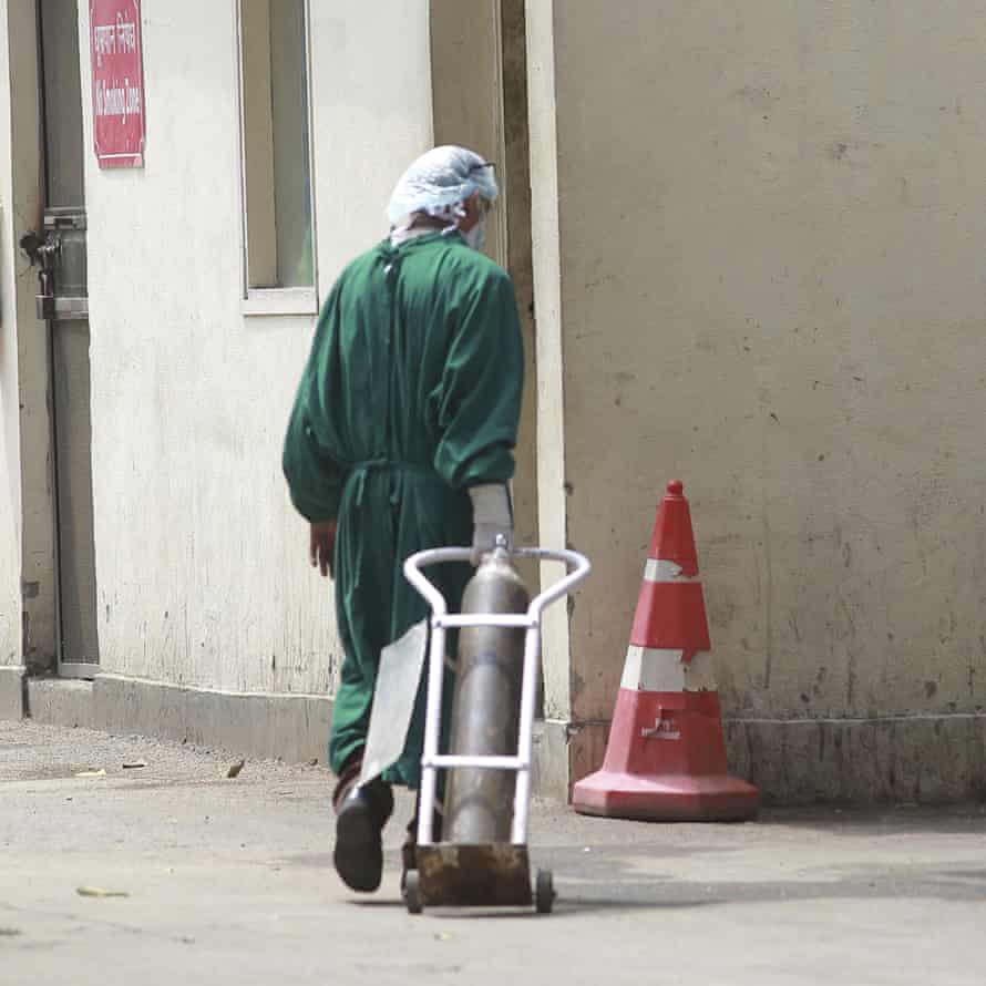 A health worker moves an oxygen cylinder at Sir Ganga Ram hospital.