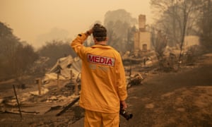 An ABC photographer Matt Roberts reacts to seeing his sister’s house destroyed by a bushfire in Quaama, NSW. The ABC plans to make its national head of emergency broadcasting redundant.