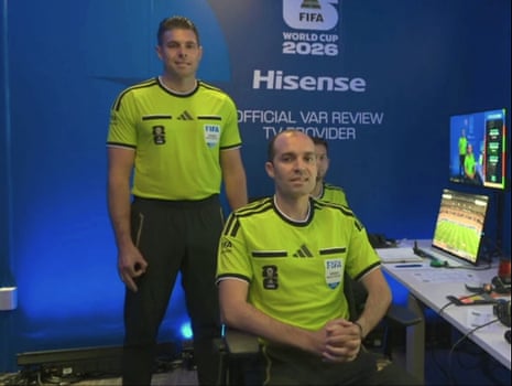 Shaun Evans (left) makes the controversial hand gesture while being introduced as a video assistant referee before Germany v Curaçao