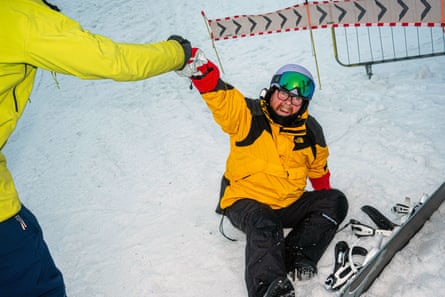 Hand helping man to feet in snow