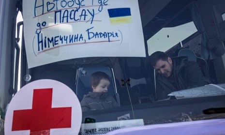 A boy on a bus for refugees from Ukraine in Przemysl, south-eastern Poland, taking them to Passau in Germany
