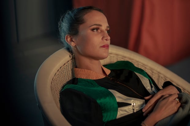 Alicia Vikander looking sorrowfully into the distance in Irma Vep.