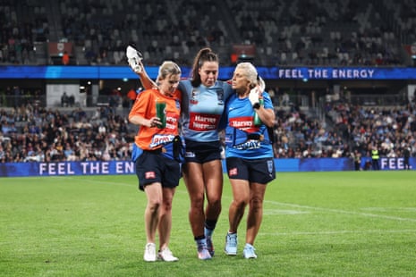 Isabelle Kelly gets some help as she leaves the field.