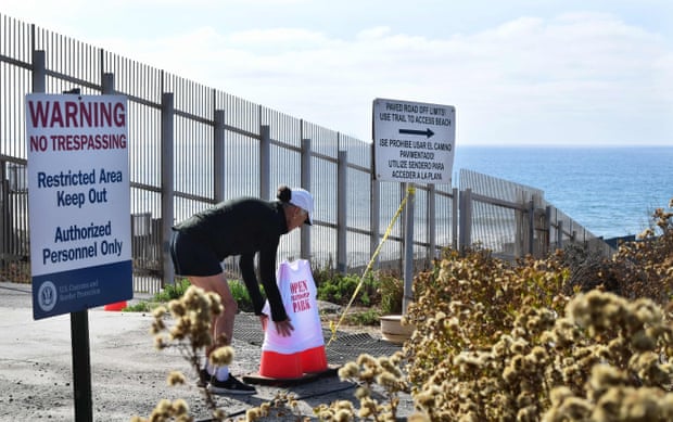 The documentary photographer Maria Teresa Fernandez positions a T-shirt reading ‘Open Friendship Park’ into two barrier cones at Friendship Park in Imperial Beach, California in November 2021.