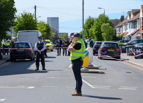 Police officers at the scene in Golders Green, north-west London, after two people were stabbed.