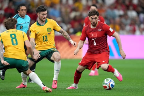 Turkey's Orkun Kokcu (6) challenges for the ball with Australia's Aiden O'Neill (13)