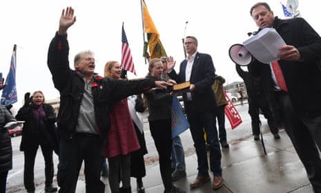 Trump supporters led by Caleb Collier, right, of the John Birch Society, swear an oath in Spokane, Washington on 6 January 2021.