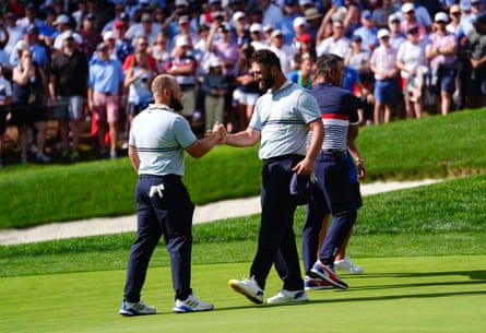 Jon Rahm and Tyrrell Hatton of Team Europe celebrate winning their foursomes match 4&3 against Bryson DeChambeau and Justin Thomas
