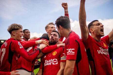 Bruno Fernandes of Manchester United celebrates with team mates after scoring their side’s first goal at Fulham.