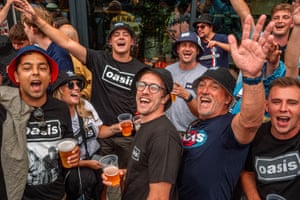 Fans cheering with beers in their hands.