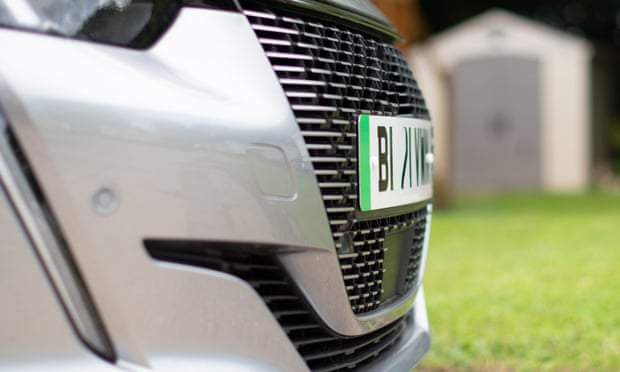 Electric e-car front grill showing close up of green stripe indicating electric on number plate