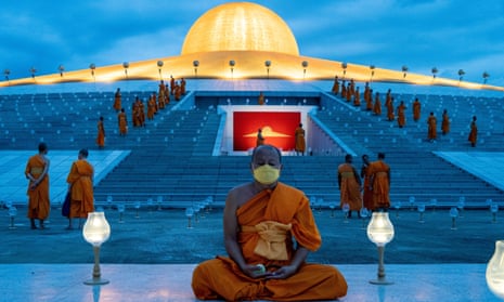  A monk meditates during a mass meditation ceremony at Wat Phra Dhammakaya temple in Thailand last August.