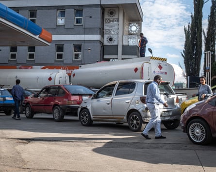 Drivers queue for fuel at a petrol station with two tankers behind, as a shortage affects daily life in Addis Ababa