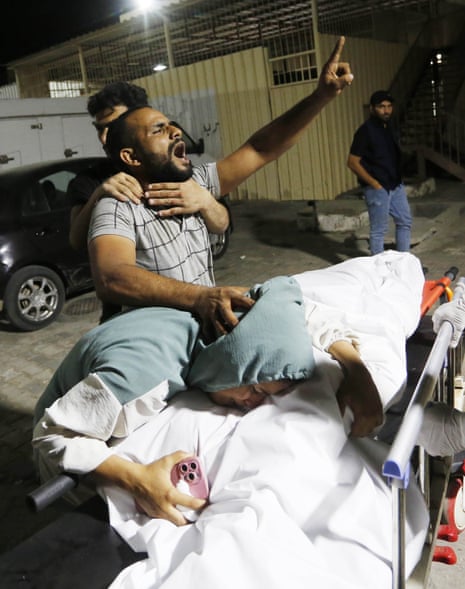 Relatives of Palestinians who died in the Israeli airstrikes mourn their loved ones at Al-Aqsa Hospital in Gaza City, Gaza on 31 October 2023.