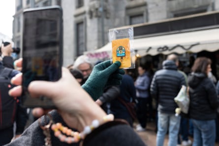 A visitor takes a photo of a free pin