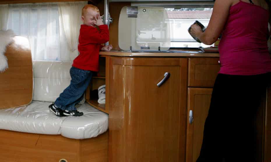 A child in a caravan, on a Traveller site in England.