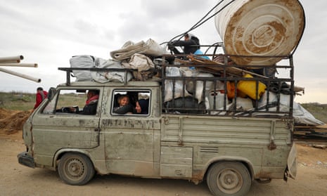 Palestinian people wait to cross through a checkpoint after Israeli forces withdrew from the Netzarim Corridor.