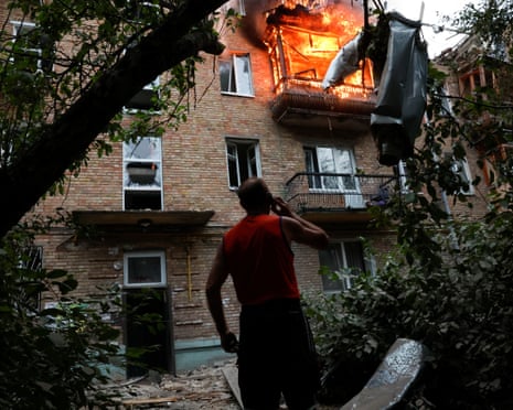 A resident looks on at the site of an apartment building hit during Russian missile and drone strikes, amid Russia’s attack on Ukraine, in Kyiv, Ukraine.