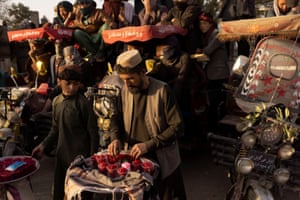 Kabul, Afghanistan, A pomegranate vendor awaits customers at a wrestling match