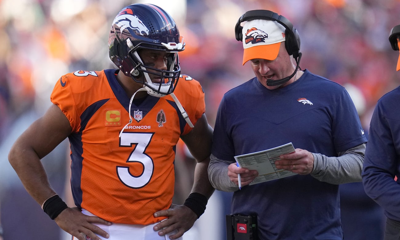 Russell Wilson and Broncos head coach Nathaniel Hackett confer during the team’s win over the Houston Texans
