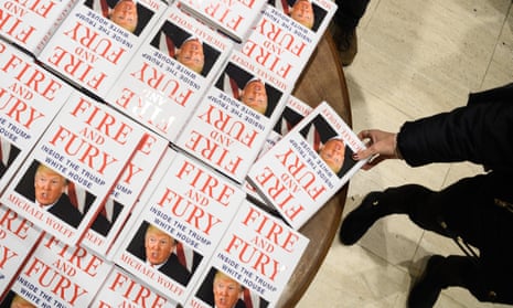 A customer takes a copy of Fire and Fury from a table in Waterstones Piccadilly in London.