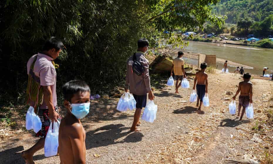 Myanmar refugees receive aid from Thailand on the Thai-Myanmar border, in Mae Sot.