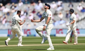 James Anderson of England celebrates taking the catch of Mitchell Santner of New Zealand off the bowling of Mark Wood who is celebrating in the background.