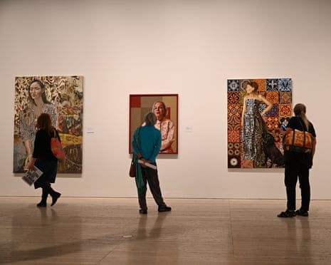 Patrons examine portraits