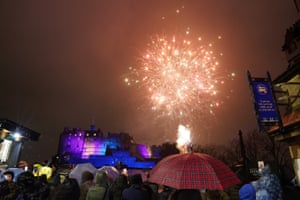 People watch fireworks at Edinburgh Castle during the Hogmanay New Year celebrations