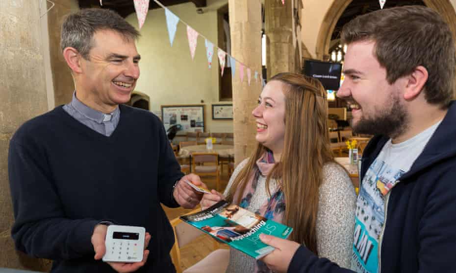 Martyn Taylor, the rector of St George’s Church in Stamford, Lincolnshire, takes a contactless payment
