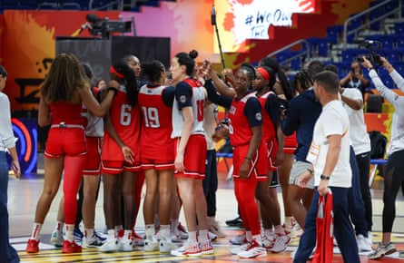 A group of Team USA players gather in a huddle.