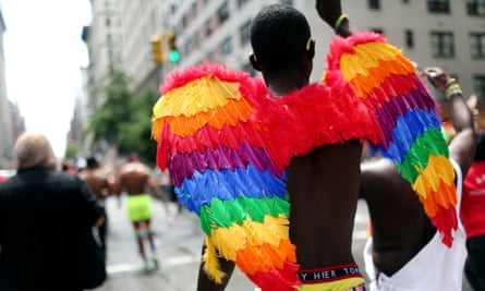 A participant wears multi-colored wings while marching in the Gay Pride parade in New York City.