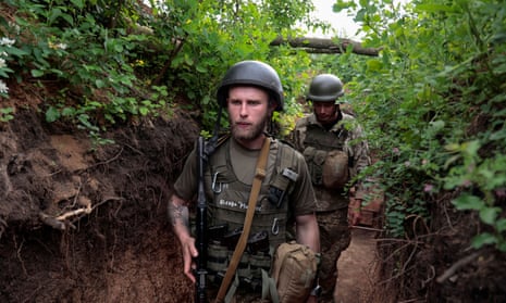 Ukrainian servicemen walk in a trench at a position near a frontline, as Russia’s attack on Ukraine continues, in Donetsk Region, Ukraine May 29, 2022.