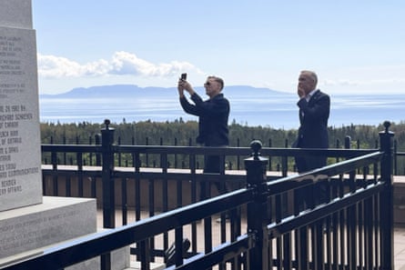 a man takes a picture of a memorial