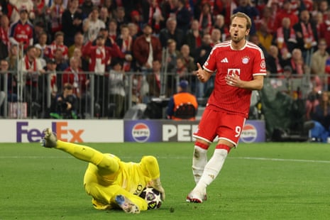 Matvey Safonov gets to the ball before Harry Kane in a frantic start in Munich.