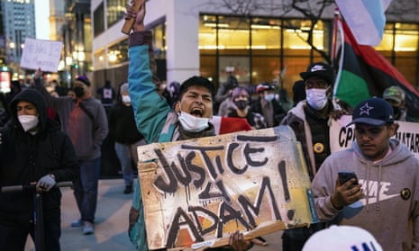 Dozens of protesters march down the Magnificent Mile after the city of Chicago released videos of 13-year-old Adam Toledo being fatally shot by a Chicago police officer, on Thursday evening.
