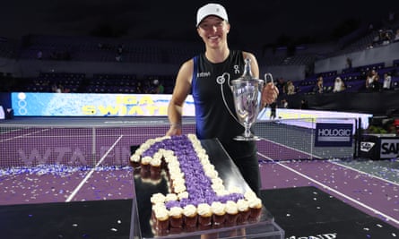 Iga Swiatek is presented with a tray of cupcakes to mark her status as the year-end No 1.