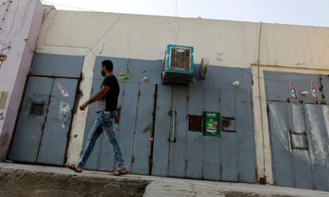 An Iraqi man walks past a closed liquor store in the capital Baghdad.