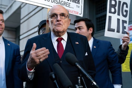 Giuliani speaking into a microphone.