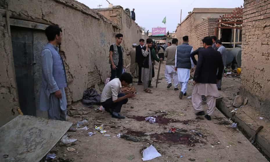 Residents gather at a site following a suicide bomb attack in an education centre in Kabul.