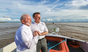 two men in white shirts clutching hands closely on a boat