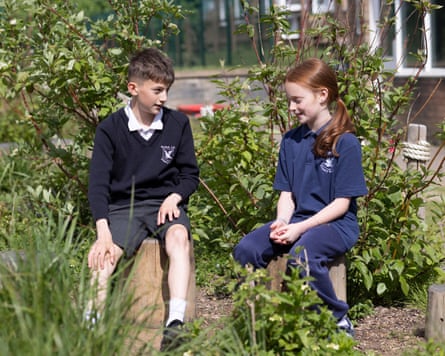 Two students sit in the garden at St John’s.