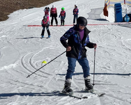 An older woman in purple skiing in Austria.