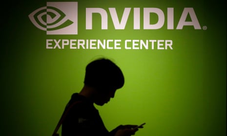 visitor walks past the Nvidia company logo