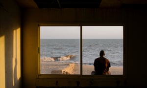 Security guard Netto Dezzimata, outside the now derelict rooms at Beira’s sailing club, where he worked