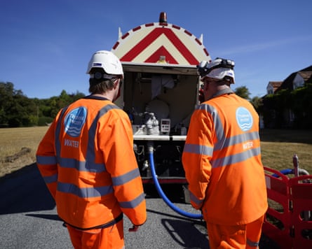 Thames Water employees deliver a temporary water supply from a tanker to the village of Northend in Oxfordshire in 2022.